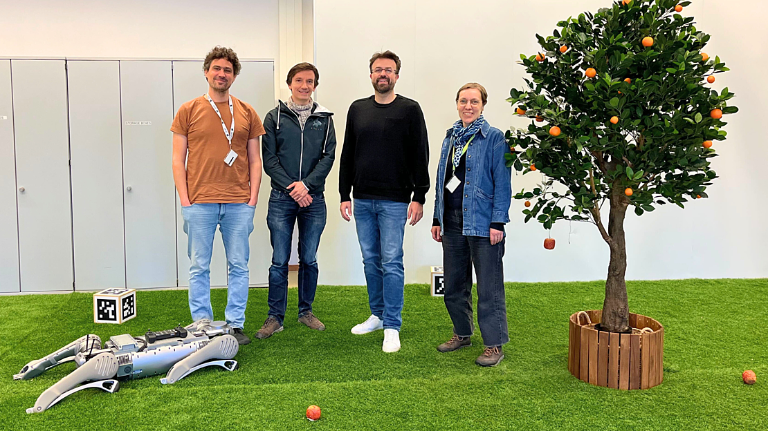 Mirko Holzer stands with the Polybot team. (left to right: Martin Kiefel, Wieland Brendel, Mirko Holzer, and Maike Kaufman)